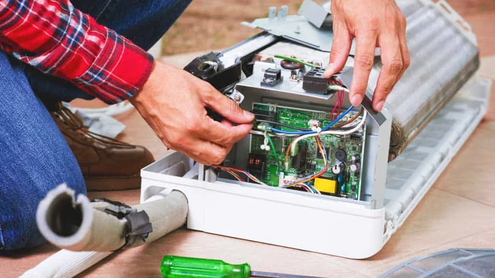 Technician working on circuit board of indoor unit
